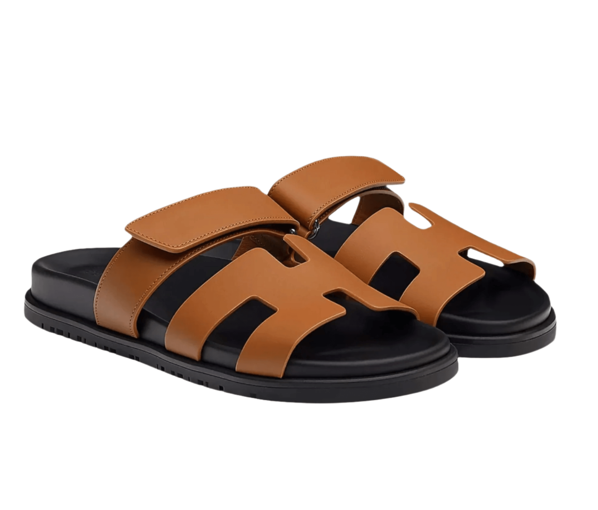 Hermès Chypre sandals in tan leather with black sole and signature H cut-out design for men and women