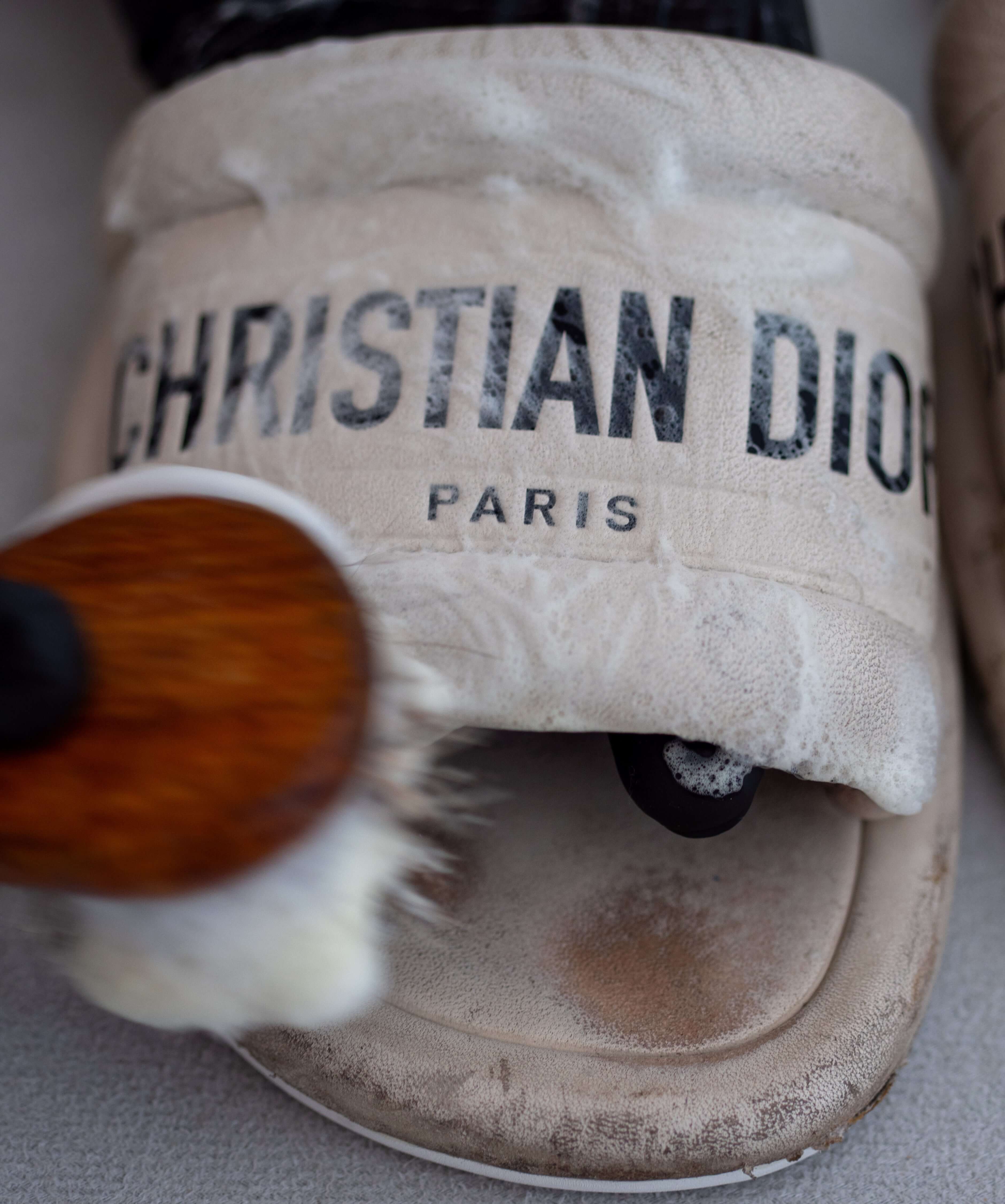 Dior Sandals being cleaned with a soapy solvent and a soft brush