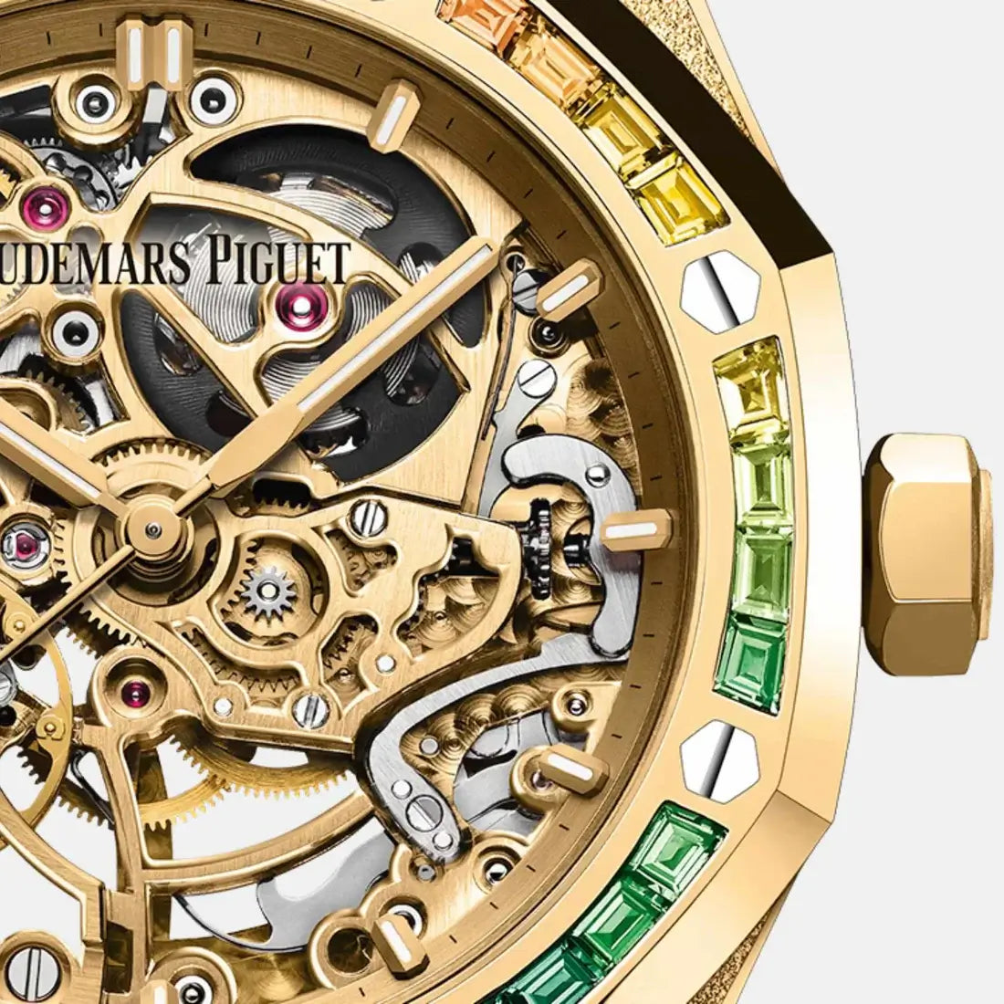 Close-up of a gold watch with visible brand name and gemstone accents on a white background