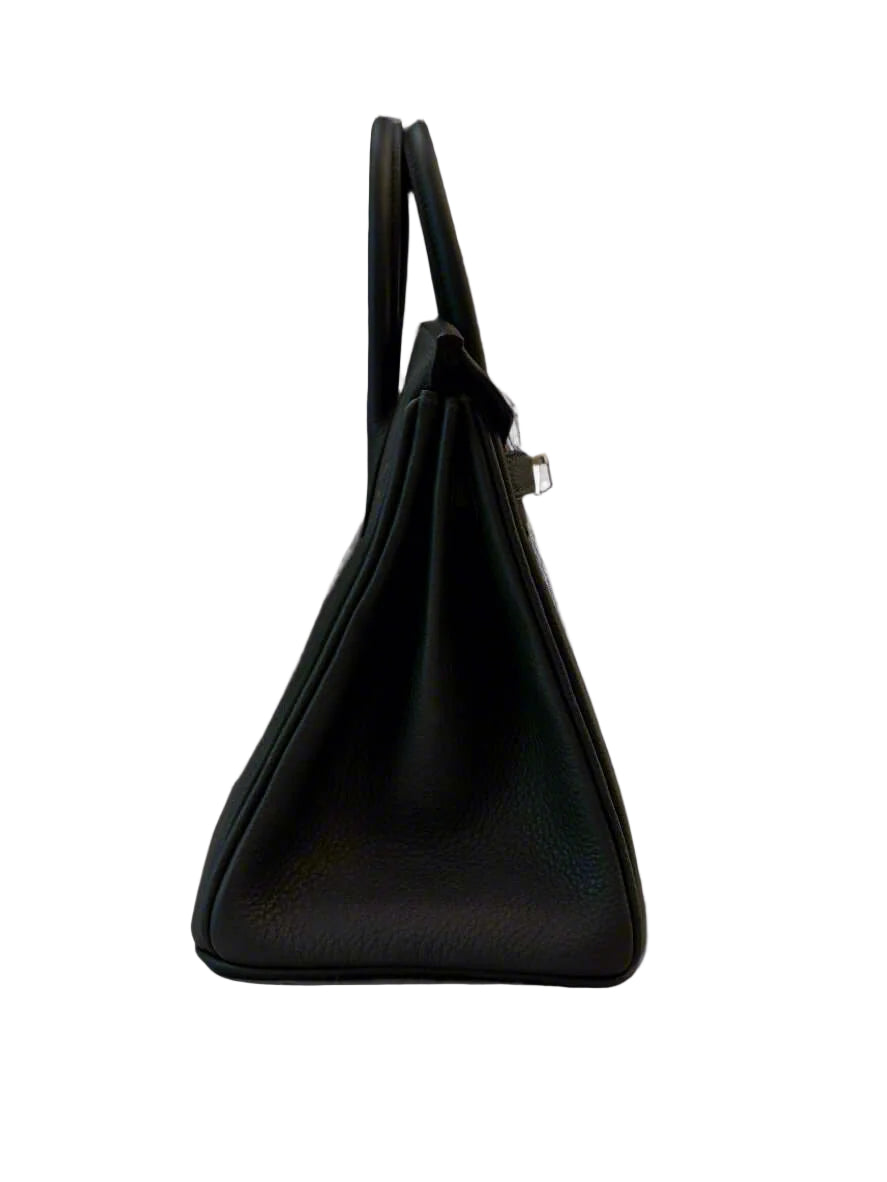 a side view of and hermes birkin 25 handbag featuring a vert fonce togo leather and palladium hardware