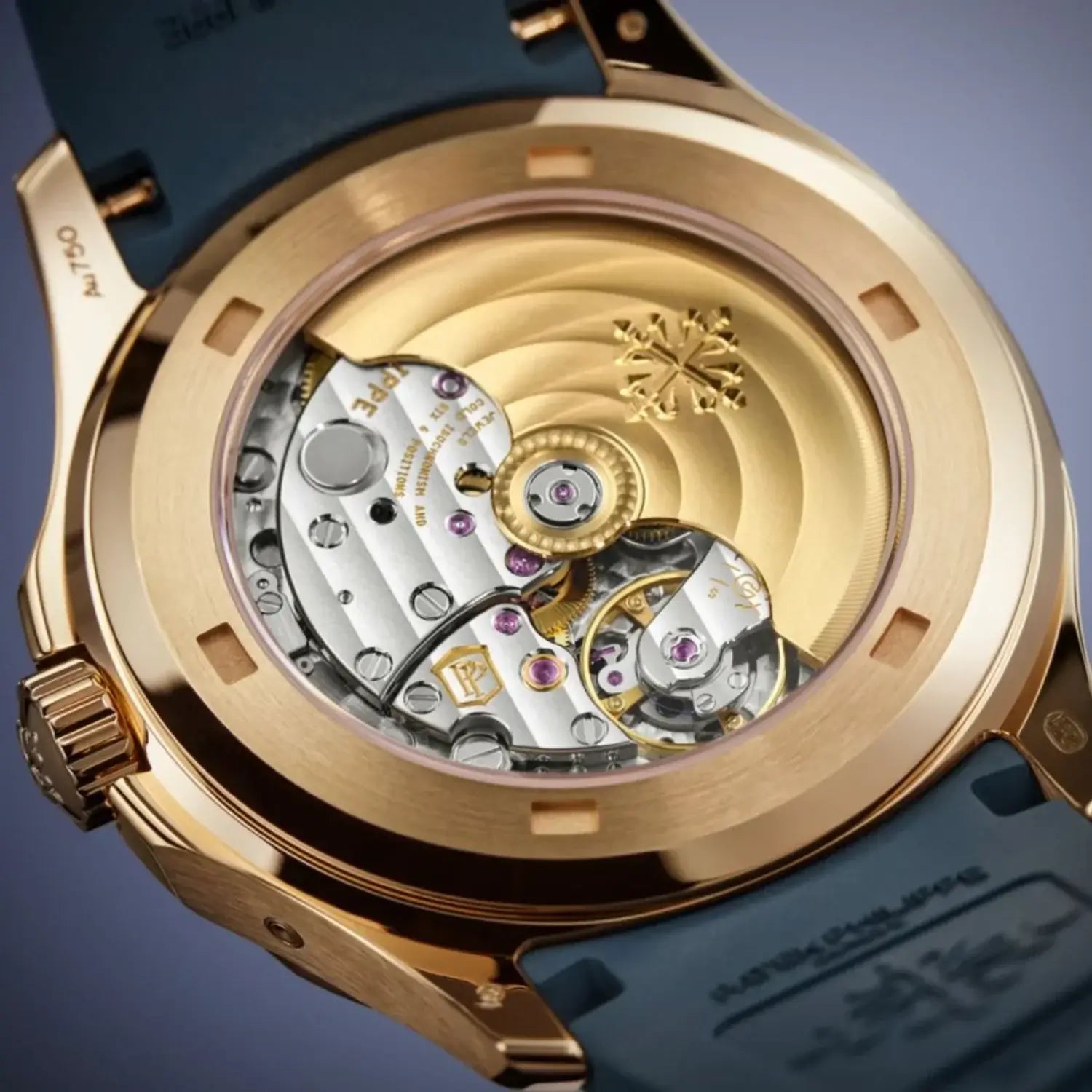 Close-up of a gold watch mechanism with blue strap on a gradient background