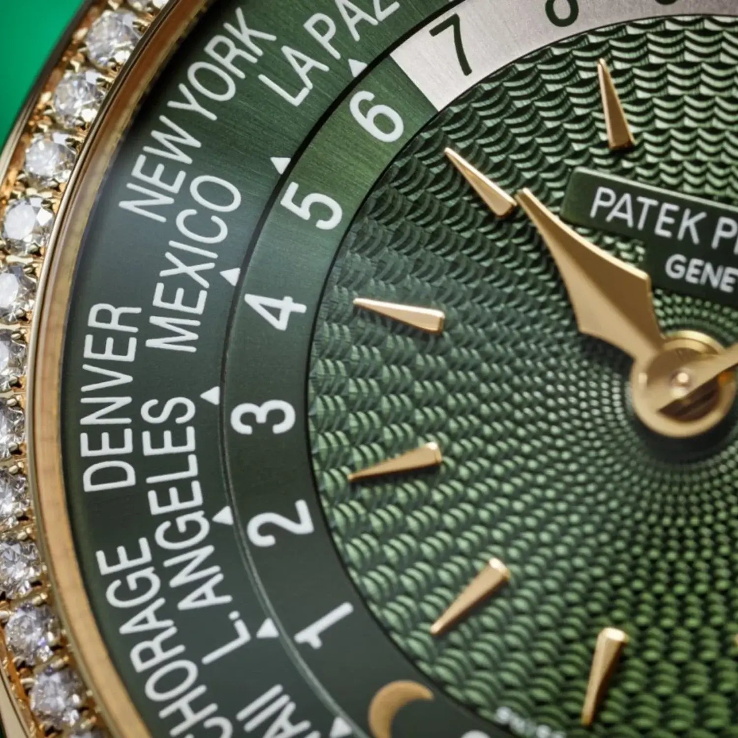 Close-up of a Patek Philippe watch with green face and gold accents