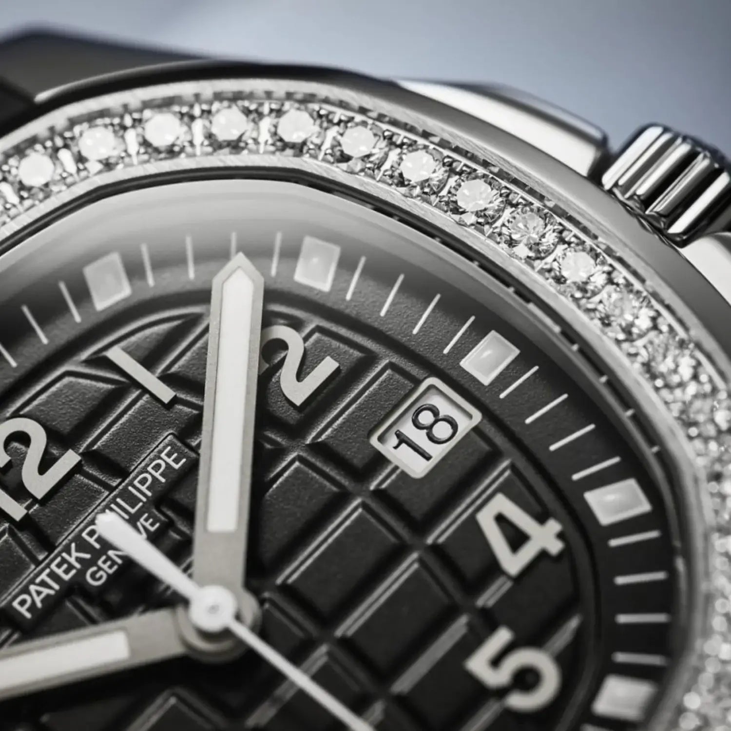 Close-up of a Patek Philippe watch face with diamond-studded bezel